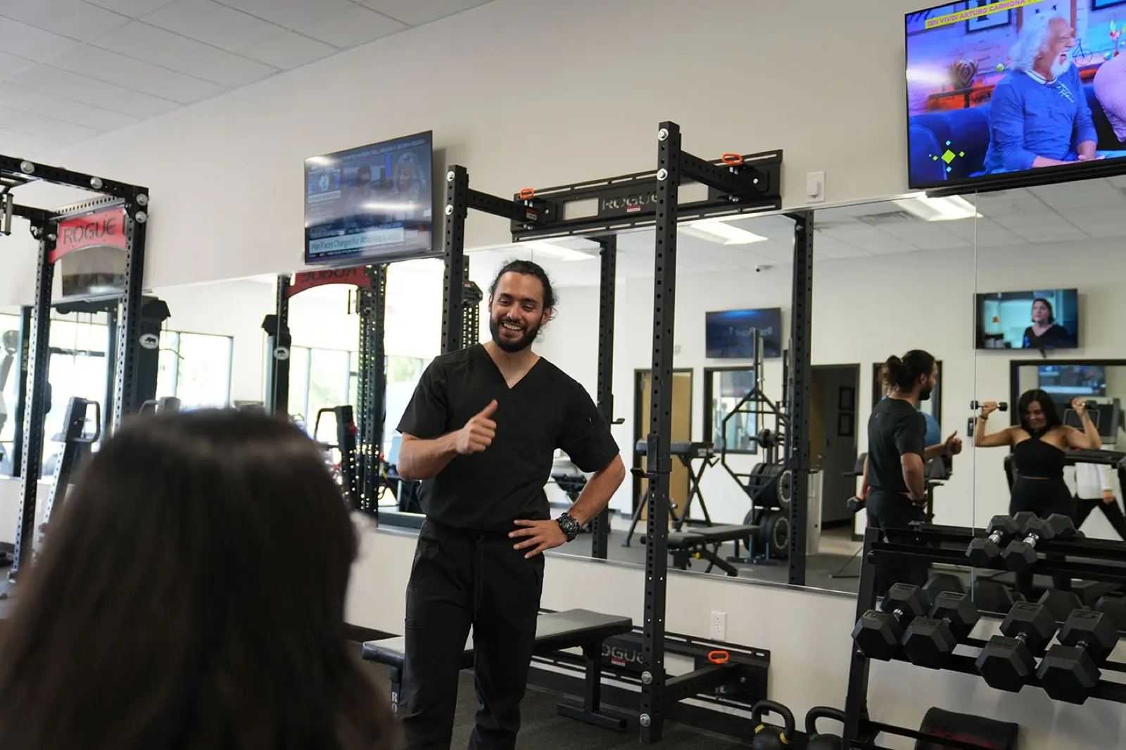 Certified trainer coaching clients during a workout at KM Wellness Center in El Paso